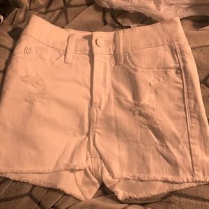 white jean shorts with rips